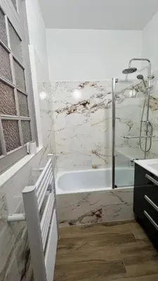 a white bathroom with a tub and a sink at Appartement Les Halles , Climatisation, Terrasse, Garage in Narbonne