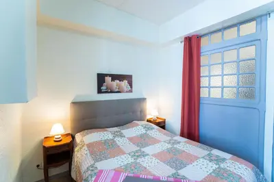 a bedroom with a bed and a window at Appartement Les Halles , Climatisation, Terrasse, Garage in Narbonne