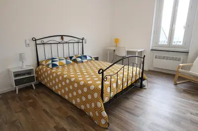 a bedroom with a bed and a wooden floor at T3 proche de la mer in Portel-des-Corbières