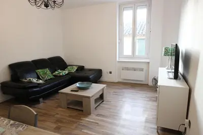 a living room with a black leather couch and a coffee table at T3 proche de la mer in Portel-des-Corbières