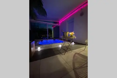 a house with a swimming pool with purple lights at Koh Samet Siam Manahakhon Appart & Spa in Rieux-de-Pelleport