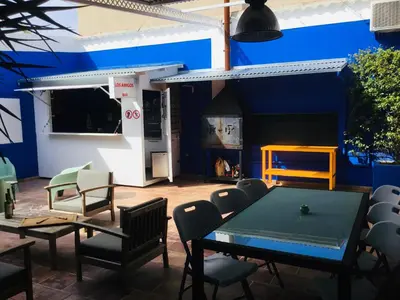 a room with a table and chairs and a blue wall at Casa Léon in Narbonne