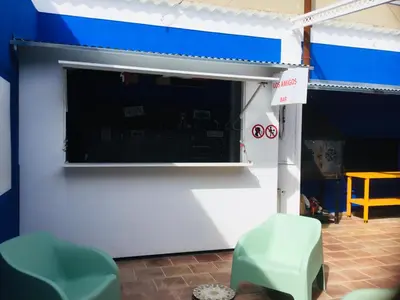 a blue and white garage with a large window at Casa Léon in Narbonne