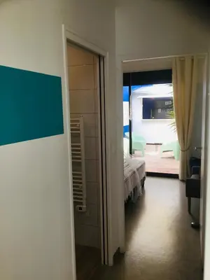 a room with a bed and a door to a bedroom at Casa Léon in Narbonne