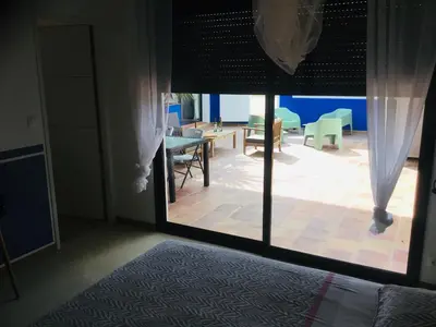 a room with a large glass door with a patio at Casa Léon in Narbonne