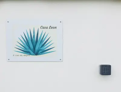 a sign on a wall next to a remote control at Casa Léon in Narbonne