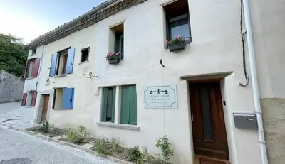 a white building with windows and a door at Maria Magdalena Apartments in Rennes-le-Château