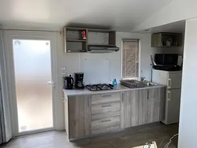 a kitchen with a sink and a counter top at Le Solèou in Port-la-Nouvelle