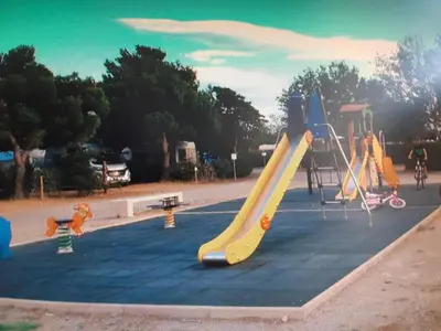 a playground with a slide in a park at Le Solèou in Port-la-Nouvelle