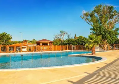 a large swimming pool in a yard with a house at Le Solèou in Port-la-Nouvelle