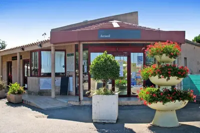 a store with potted plants in front of it at Le Solèou in Port-la-Nouvelle