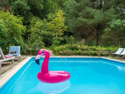 a pink flamingo float in a swimming pool at Horizons Verts Appartement Cerisier in Puivert