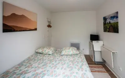 a bedroom with a bed and a television in it at Horizons Verts Appartement Cerisier in Puivert