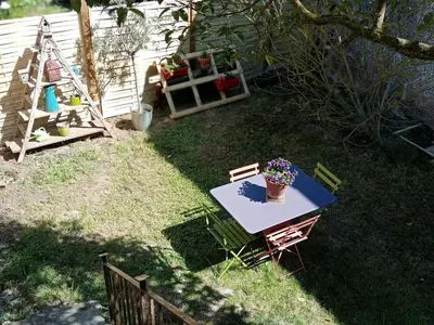 a table with a potted plant on it in a yard at Une perle dans la malepère. in Montréal