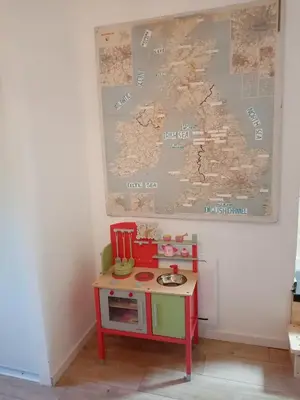a play room with a table and a map on the wall at Une perle dans la malepère. in Montréal