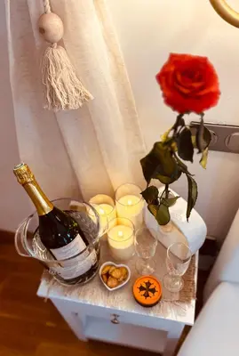 a table with a bottle of champagne and candles at Chambres d'hôtes Château de Jonquières in Narbonne