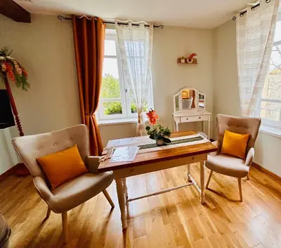 a living room with a table and two chairs at Chambres d'hôtes Château de Jonquières in Narbonne