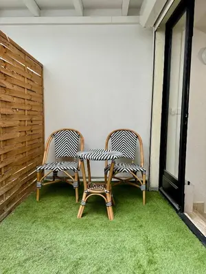 two chairs sitting on a patio with grass at 102 - Cheminée de la Bastide in Carcassonne