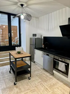 a kitchen with a table and a counter top at 102 - Cheminée de la Bastide in Carcassonne