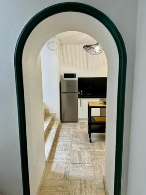 an archway leading into a kitchen with a table at 102 - Cheminée de la Bastide in Carcassonne