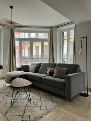 a living room with a couch and a table at 102 - Cheminée de la Bastide in Carcassonne