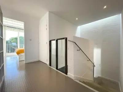 a white hallway with a staircase in a house at Villa des Cathares in Carcassonne