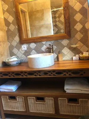 a bathroom with a sink and a mirror at Fanjeaux Aude Le Chalet in Fanjeaux