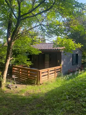 a cabin with a fence and a tree at Fanjeaux Aude Le Chalet in Fanjeaux