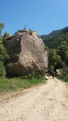 a large rock on the side of a dirt road at La petite étape in Duilhac