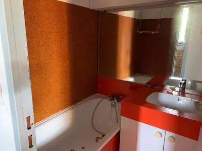 a bathroom with a bath tub and a sink at Les Drom's studio in Gruissan