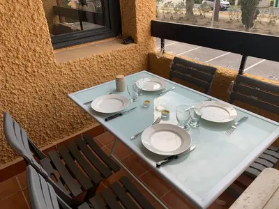 a table with plates and silverware on top at Les Drom's studio in Gruissan