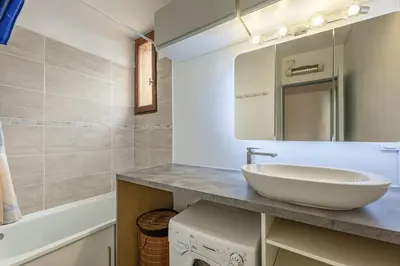 a bathroom with a sink and a mirror at La Brigantine in Gruissan