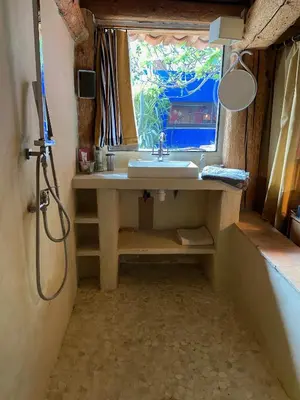a bathroom with a sink and a window at maison dans jardin in Villesèque-des-Corbières