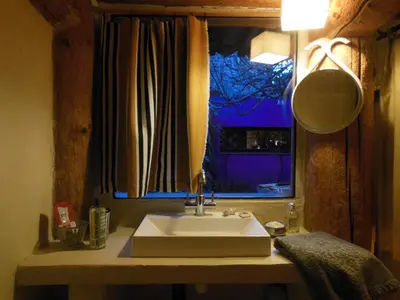 a bathroom with a sink and a window at maison dans jardin in Villesèque-des-Corbières
