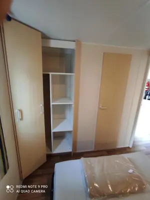 an empty room with a bed and a closet at Mobil home 5-6 personnes - climatisé in Port-la-Nouvelle