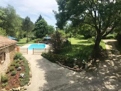 a driveway leading to a yard with a swimming pool at Gîtes de Montcabirol - Malepère in La Bastide-de-Bousignac