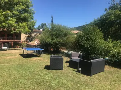 a yard with a ping pong table and trees at Gîtes de Montcabirol - Malepère in La Bastide-de-Bousignac