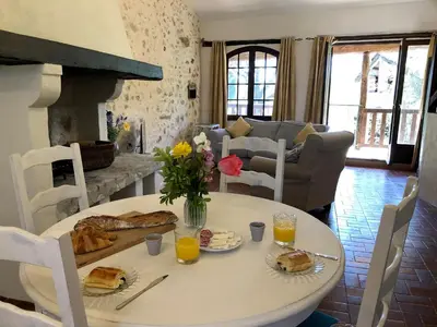 a table with food and flowers on it in a living room at Gîtes de Montcabirol - Malepère in La Bastide-de-Bousignac