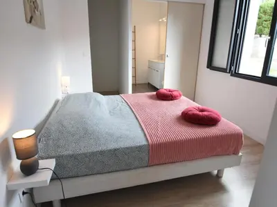 a bedroom with a bed with two red pillows on it at Villa with Pool & Views in Oupia