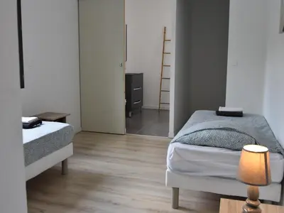 a small bedroom with two beds and a mirror at Villa with Pool & Views in Oupia