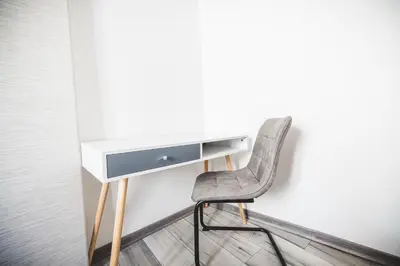 a desk and a chair next to a wall at La cathédrale à portée de main ! in Narbonne