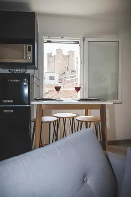 a kitchen with a bar with two glasses of wine at La cathédrale à portée de main ! in Narbonne