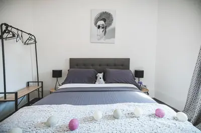 a bedroom with a bed with pink eggs on it at La cathédrale à portée de main ! in Narbonne