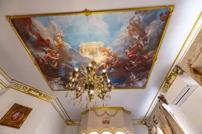 a painting on the ceiling of a building with a chandelier at Suite Royale Maison de l'église du couvent in Narbonne