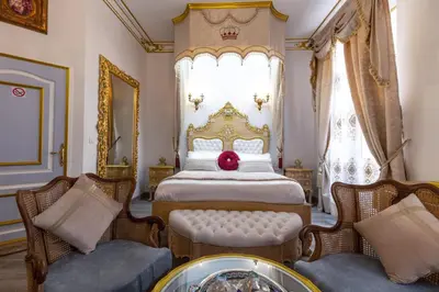 a bedroom with a bed with a red ball on it at Suite Royale Maison de l'église du couvent in Narbonne