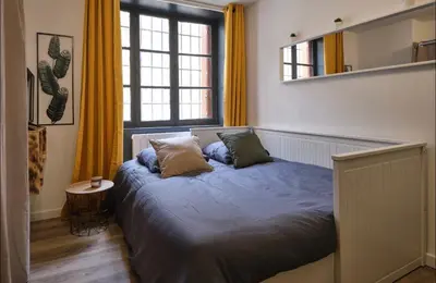 a bedroom with a bed with two pillows on it at Chez Juliette - Appart & Studios - Carcassonne centre in Carcassonne