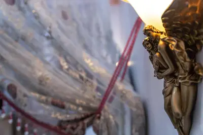 a close up of a lamp with a gold angel on it at Studio Romantique Maison de L'église du Couvent in Narbonne