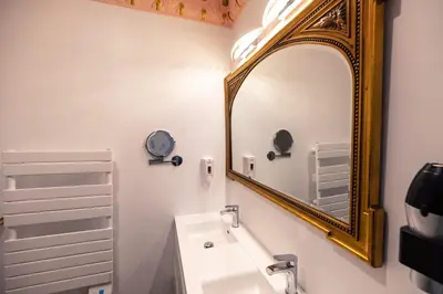 a bathroom with a mirror and a sink at Studio Romantique Maison de L'église du Couvent in Narbonne