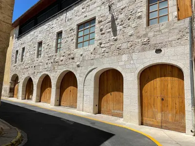 a brick building with four wooden garage doors at Suite Orientale Maison de L'église du Couvent in Narbonne
