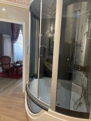 a bathroom with a shower with a glass door at Suite Orientale Maison de L'église du Couvent in Narbonne